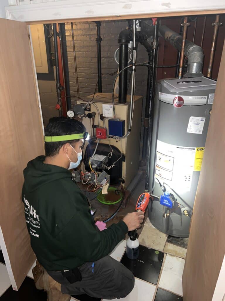 a worker servicing an hvac unit