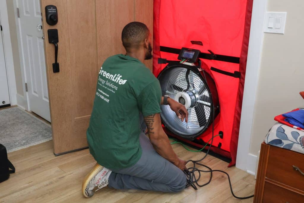 GreenLife Auditor During an Energy Audit. Blower Door test.
