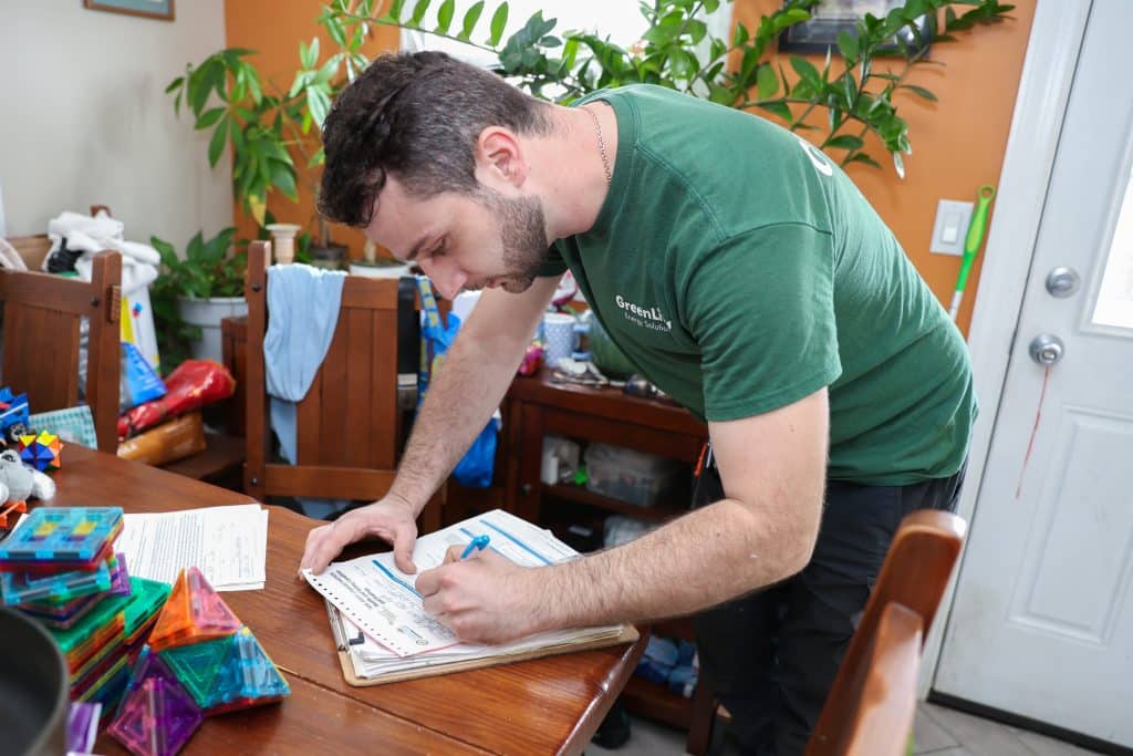 GreenLife Employee signing a document.