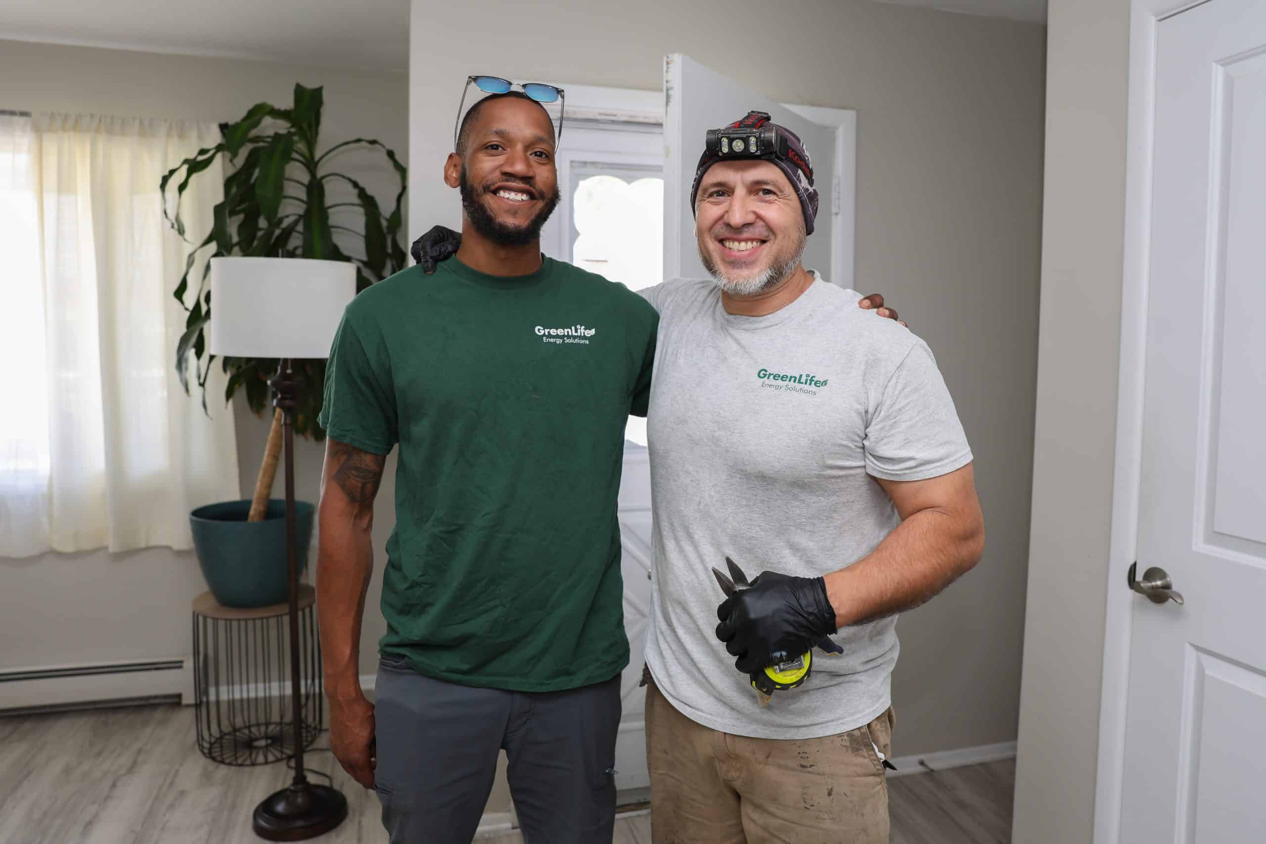 2 GreenLife employees during a weatherization job.