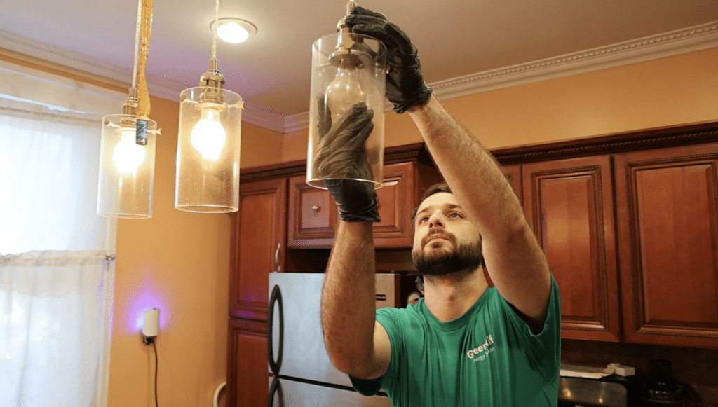 GreenLife Auditor changing a light bulb