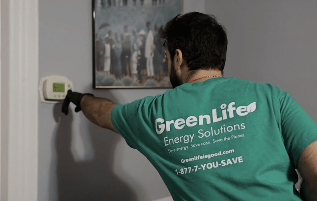 GreenLife auditor checking a thermostat